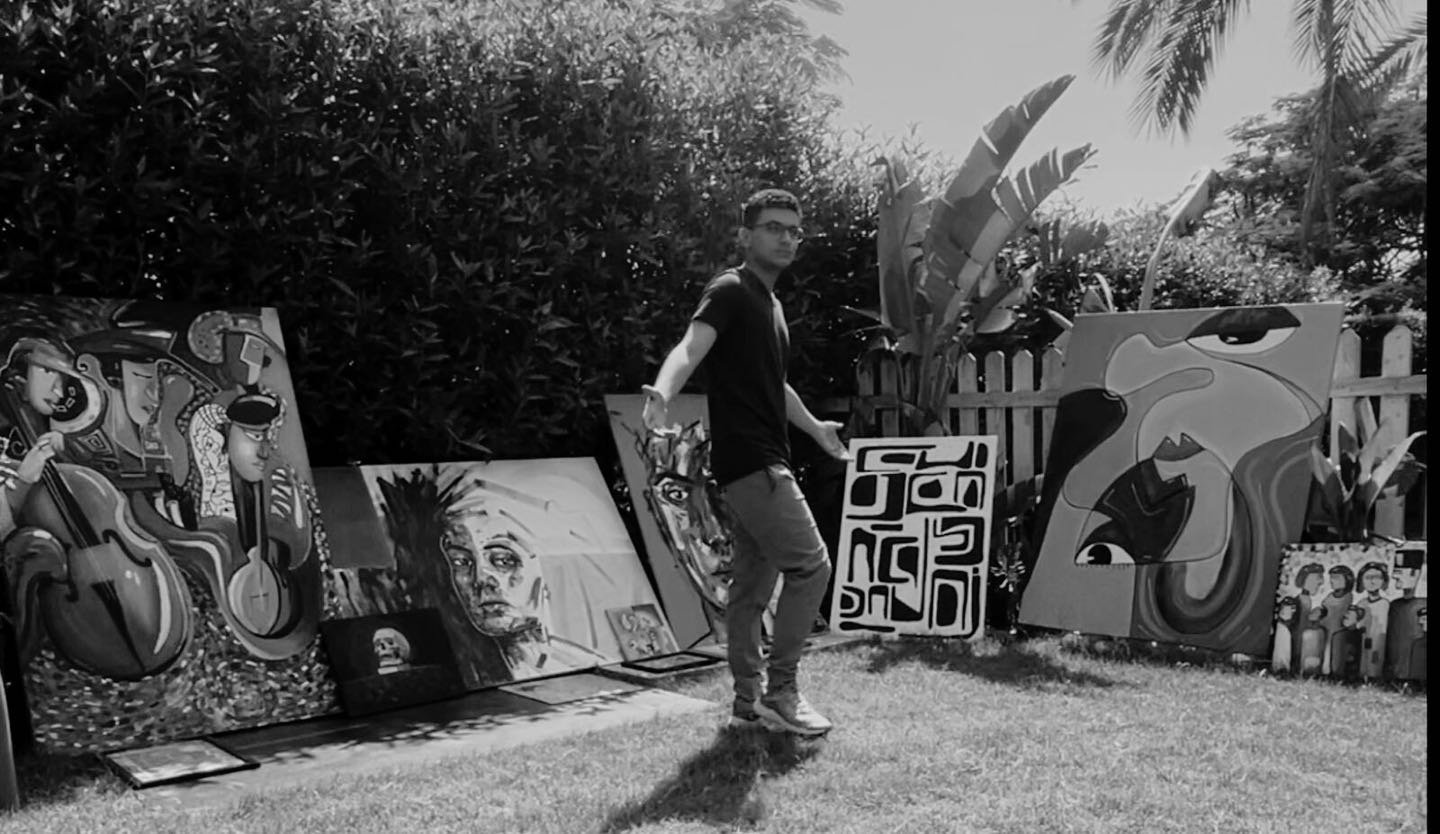 Youssef Ezz El-Din with his artworks